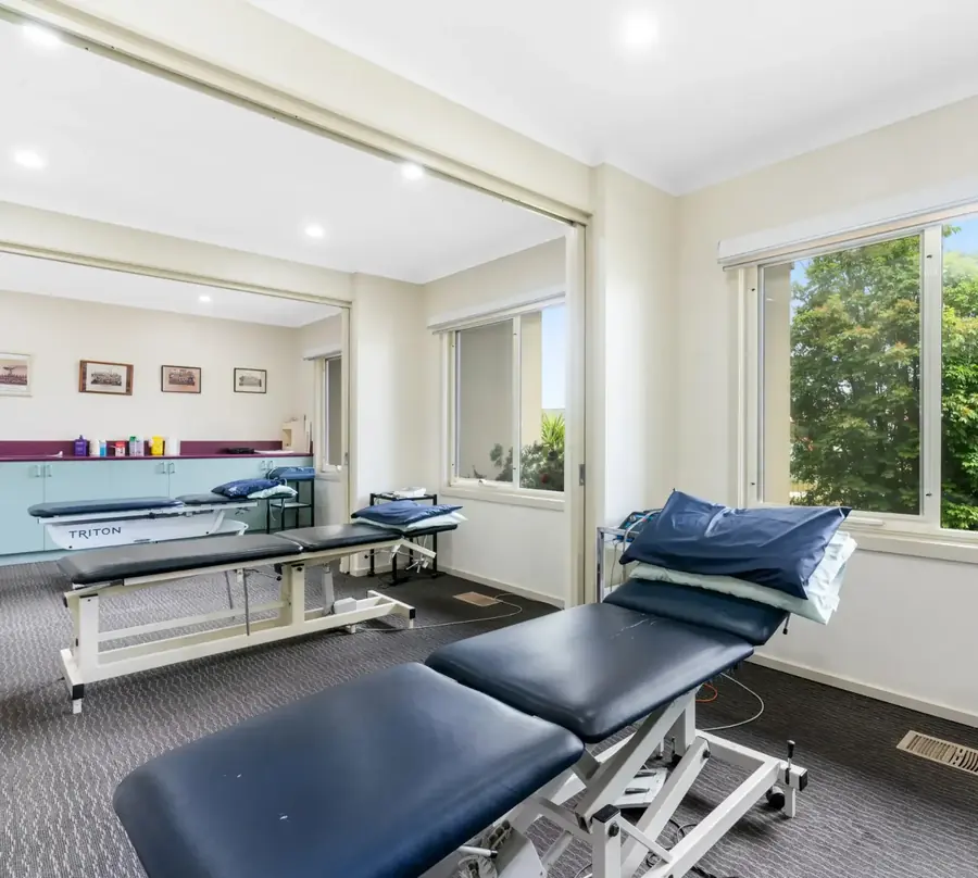 Bright treatment area with physiotherapy tables